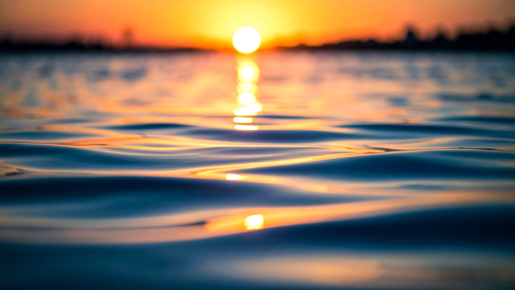 The reflection of the setting sun on the ocean water.