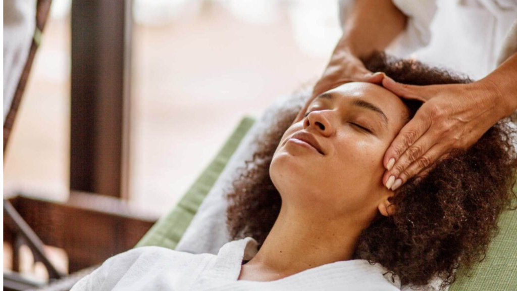 Woman enjoying a head massage at the spa.